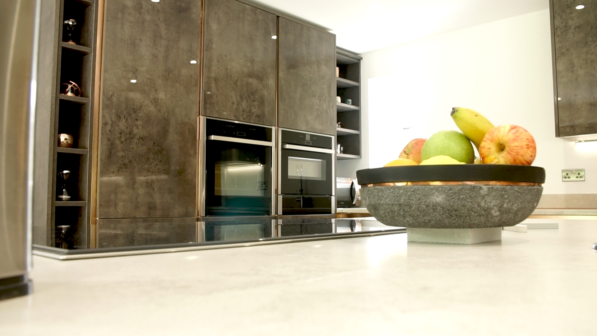 Image of a refurbished kitchen in Basingstoke with a fruit bowl in the foreground and the new cupboards in the background